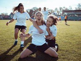 Close Up Of A Female Soccer Team Celebrating A Scored Goa