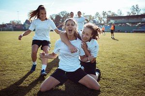 Close Up Of A Female Soccer Team Celebrating A Scored Goa